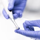 Dentist's hands using a dental drill with precision. Medical equipment focus.